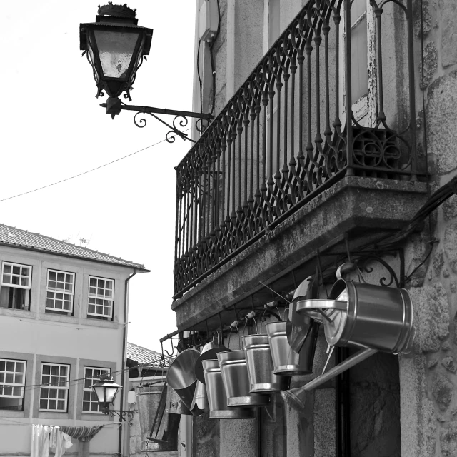 a lamp hanging from a wire near a building