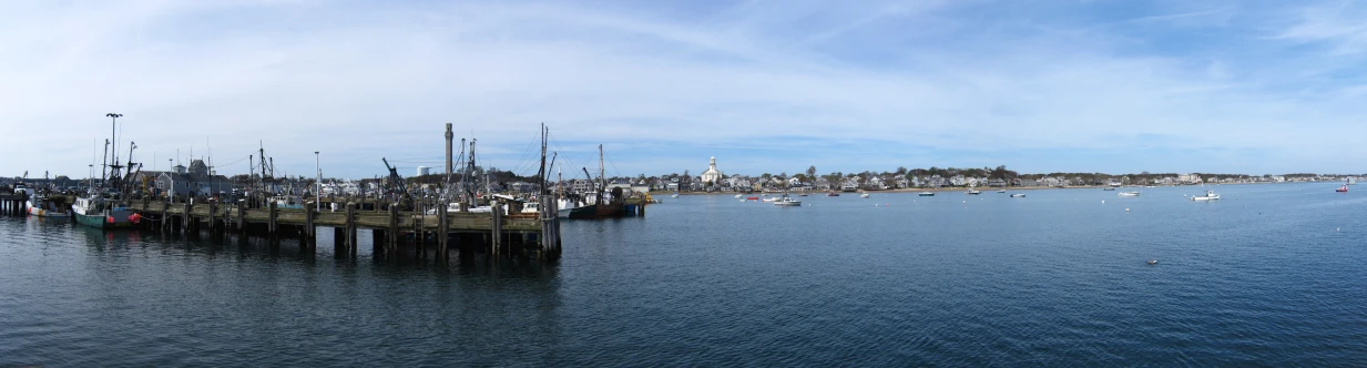 a pier filled with lots of boats in the water