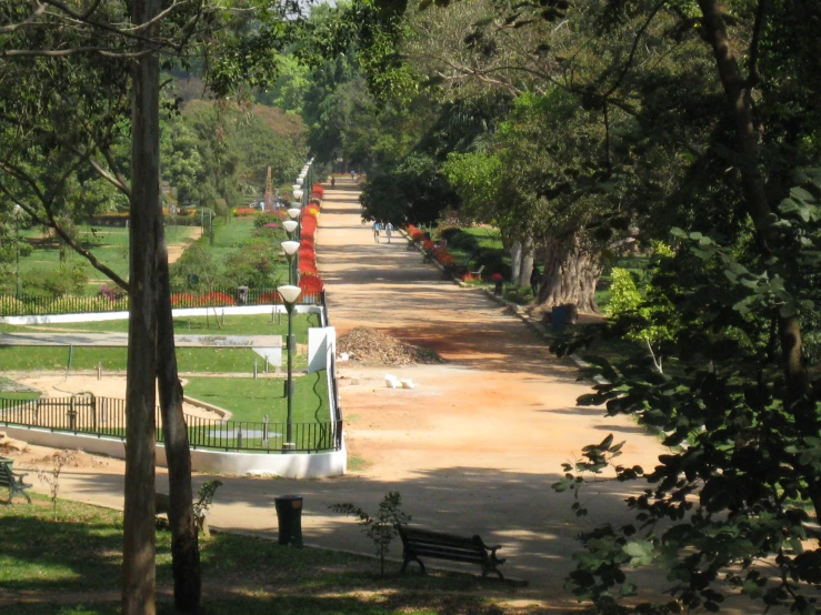 a long bench sits along a dirt road