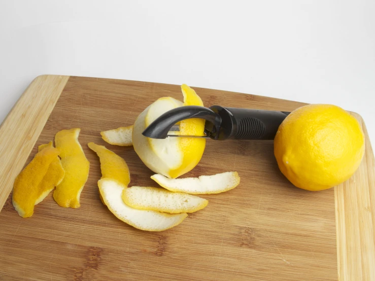 an apple and some fruit cut up on a  board