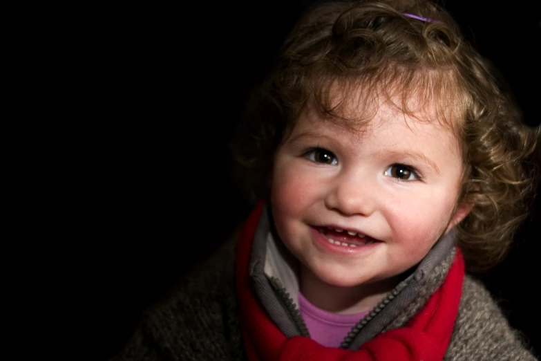 a close up of a child wearing a scarf