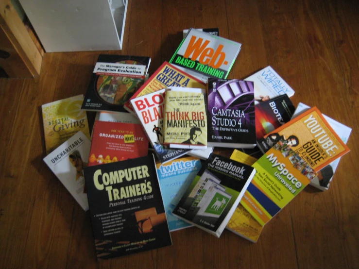 many books are stacked on the floor next to each other