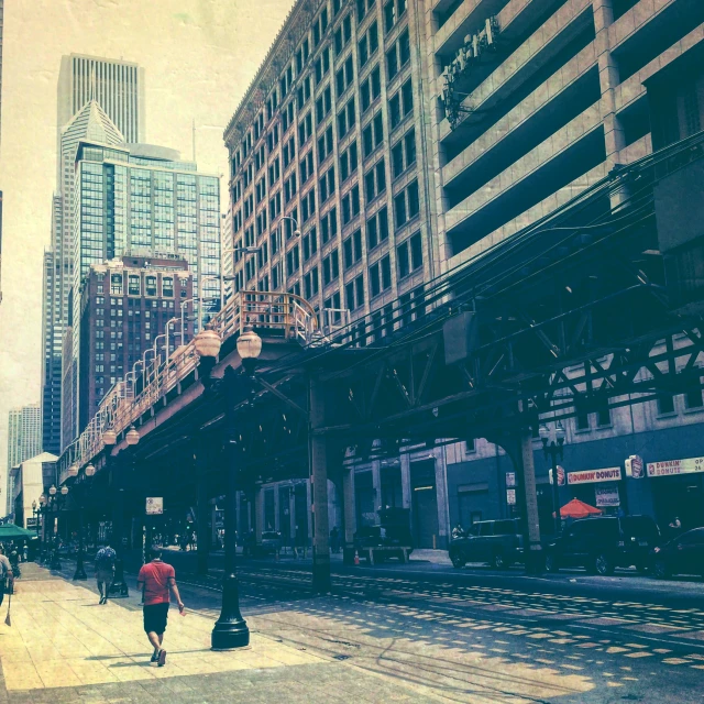 two people walking along a train track on a busy city day