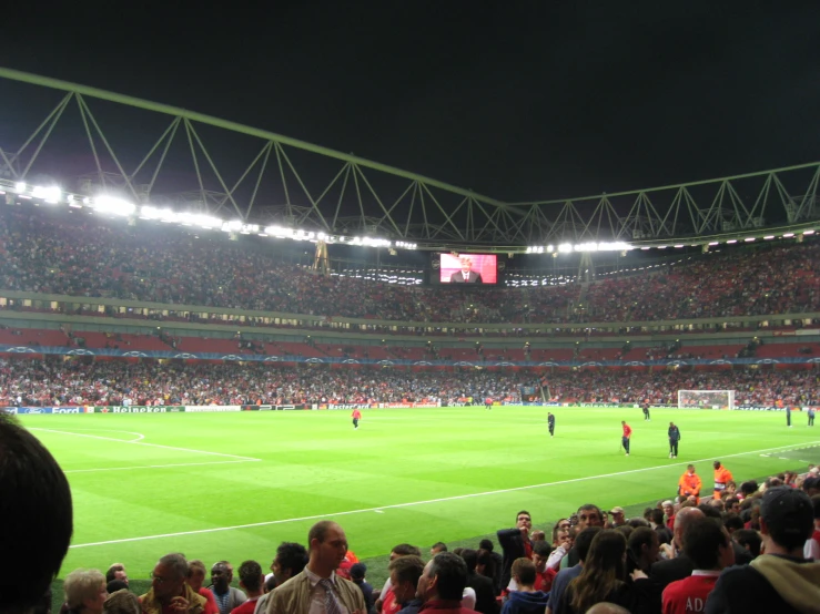 a stadium with many spectators standing around