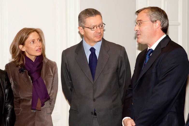 three business people are discussing with one another