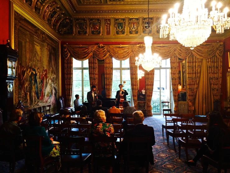 many people are gathered around a dining table