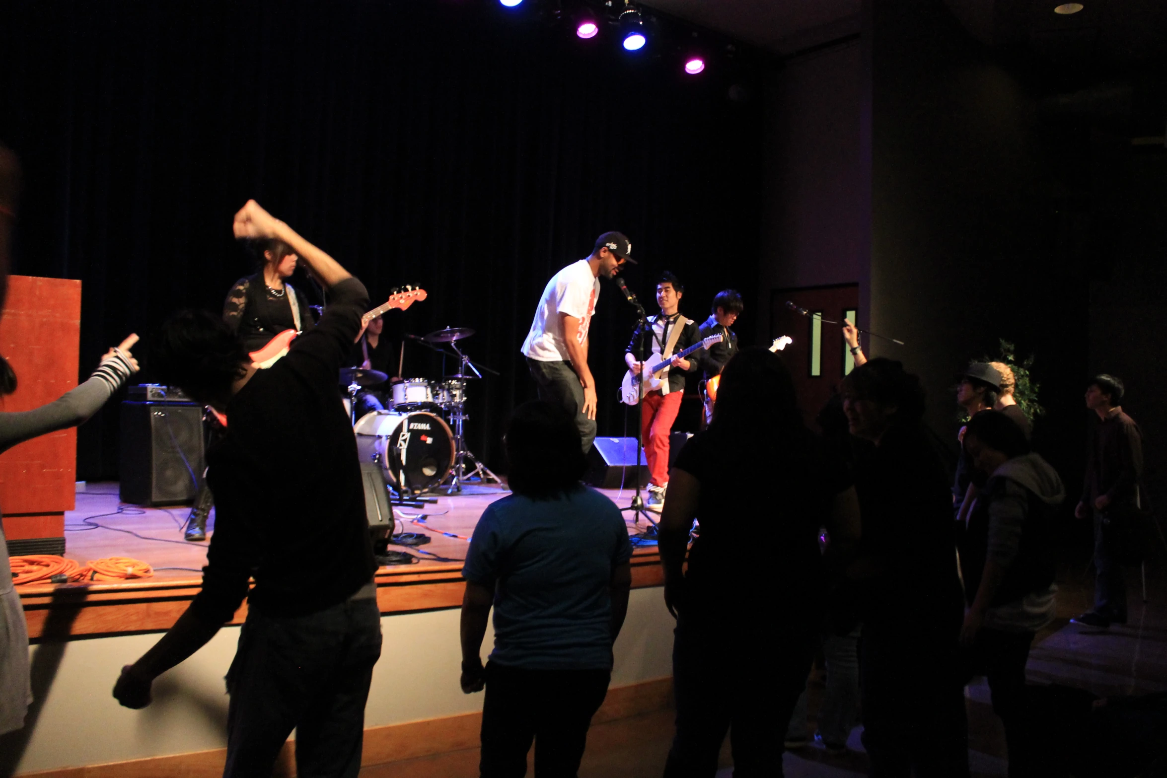 a group of people are standing on a stage