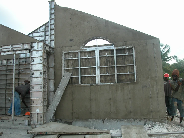 workers constructing the walls of a building in a foreign country