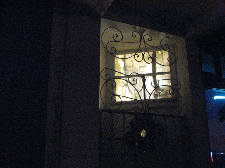 an iron screen in the window of a house