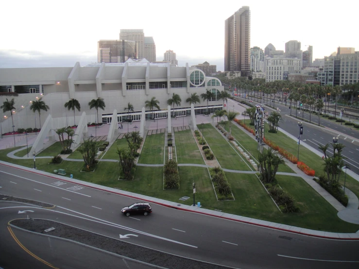 a modern looking airport with a long stretch of road behind it