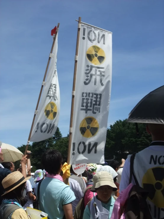 people marching with banners on a crowded area