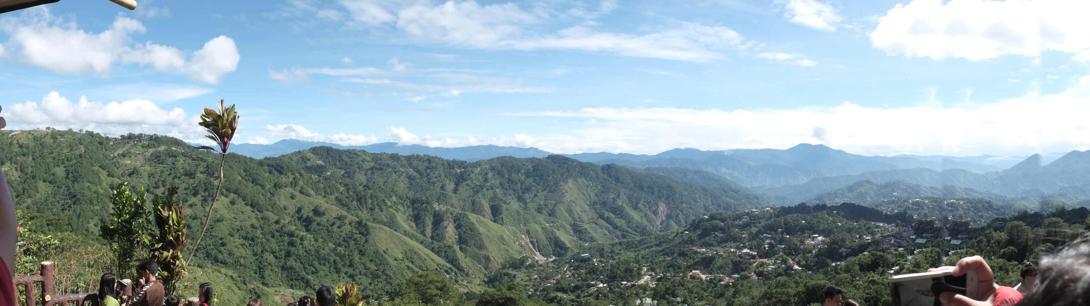 the view from the top of a hill looking at green mountains