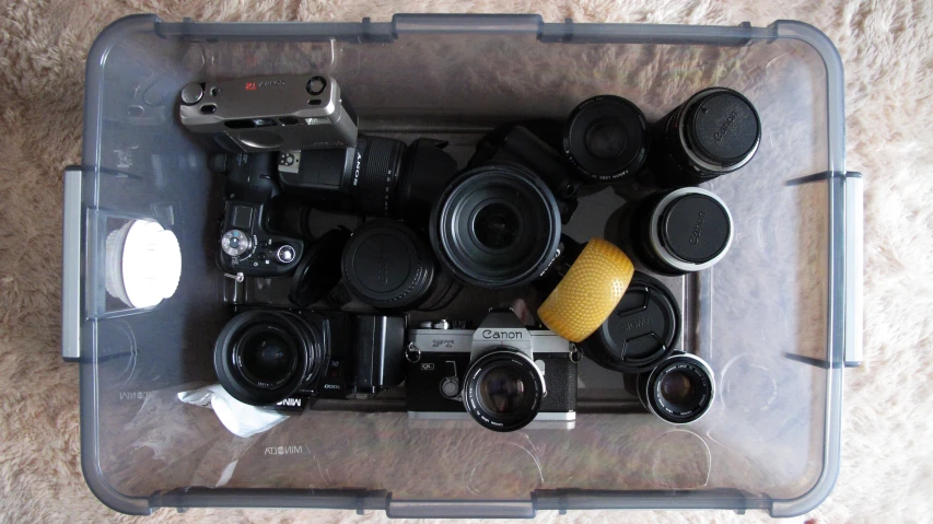 a collection of lenses are stored on a clear box