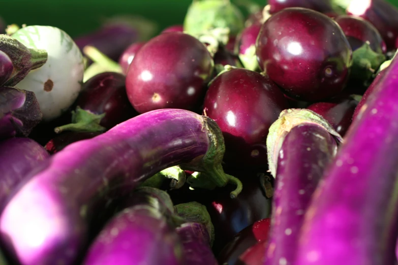 a pile of different purple fruit and vegetables