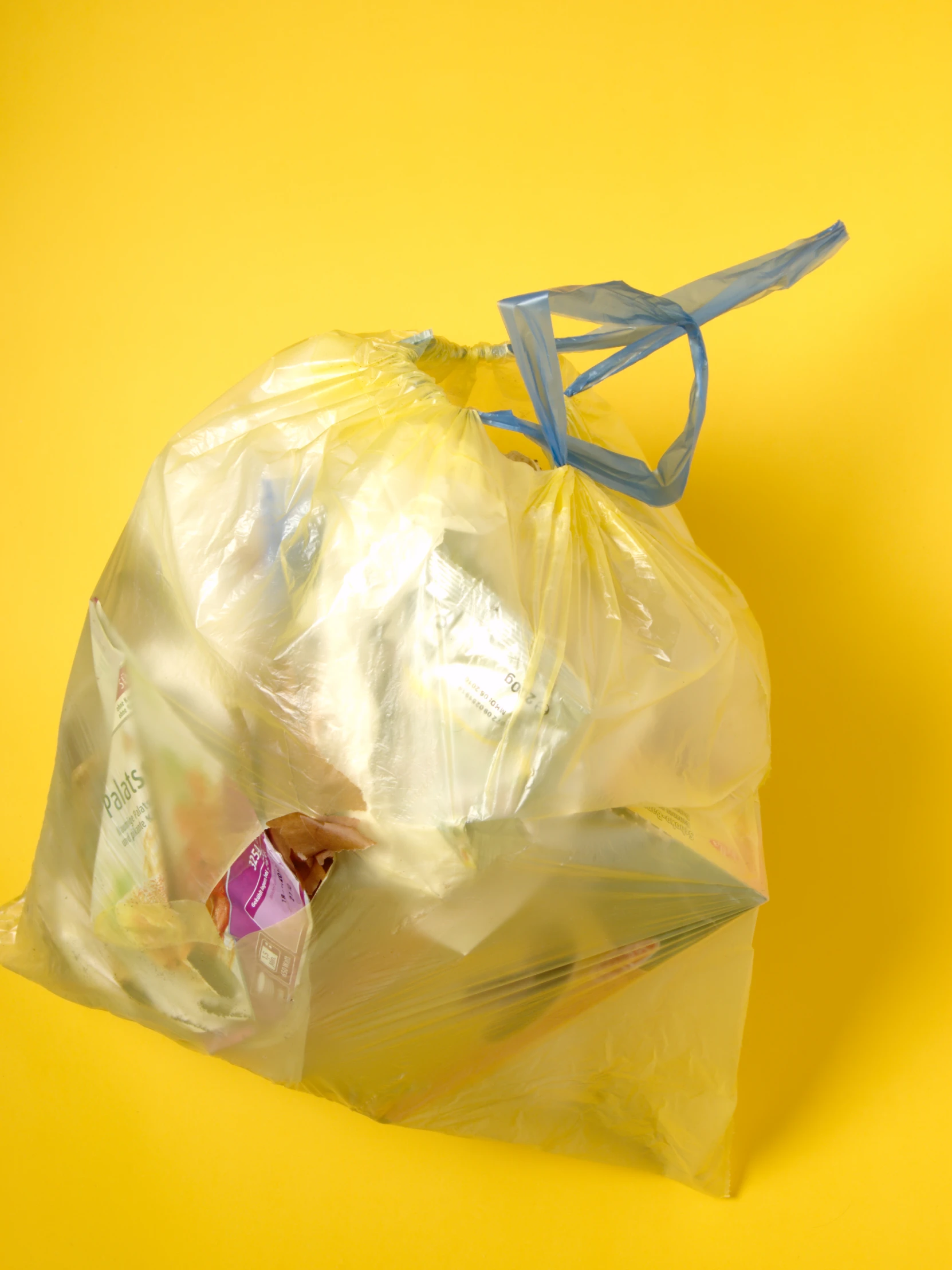 a bag on a yellow surface with some items in it