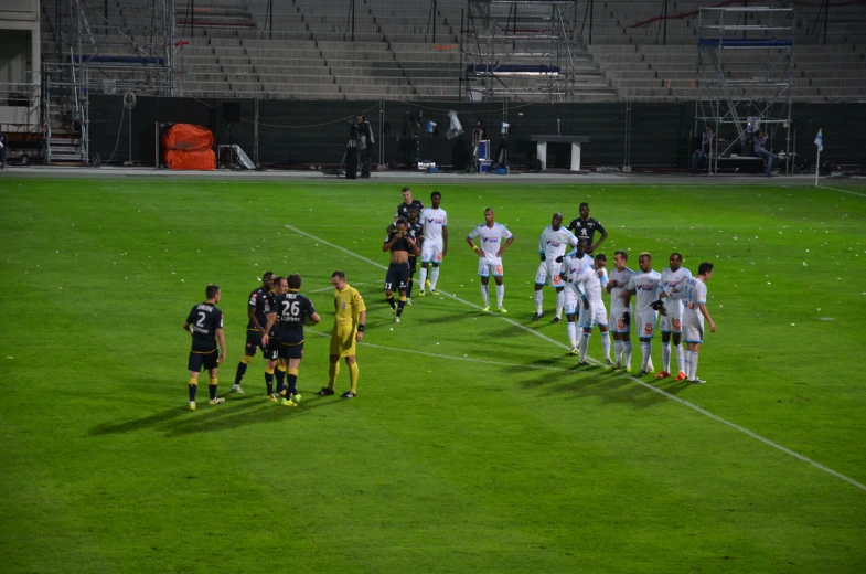 a group of soccer players standing on a field during a game