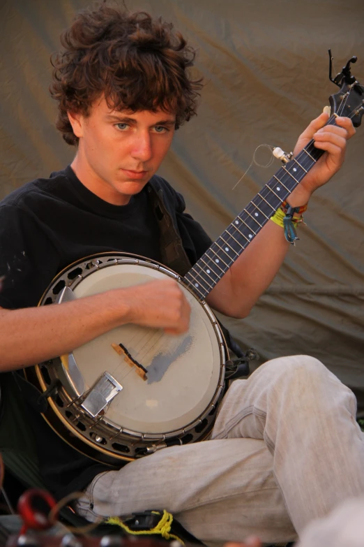 a man in black shirt holding a white guitar