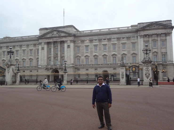 a man stands in front of the royal palace