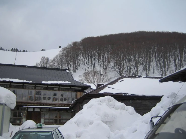 a view of a snowy mountain and house from a distance