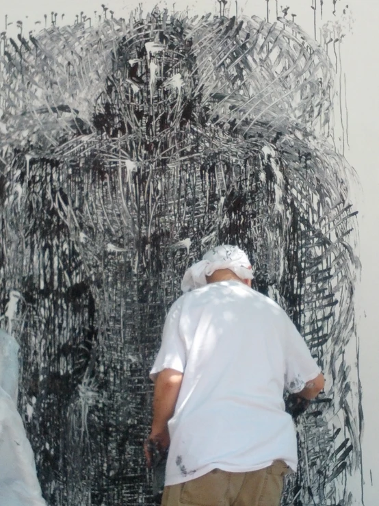 a man is standing against a drawing of a giant tree