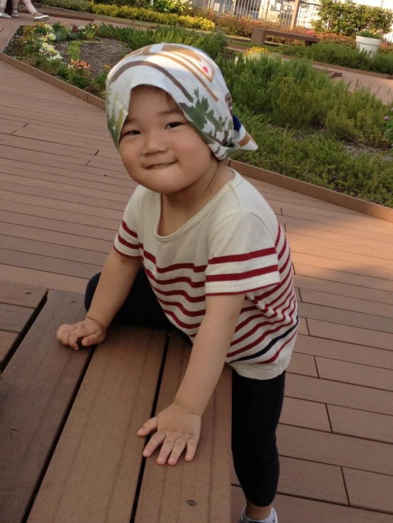 an adorable toddler boy posing on a deck