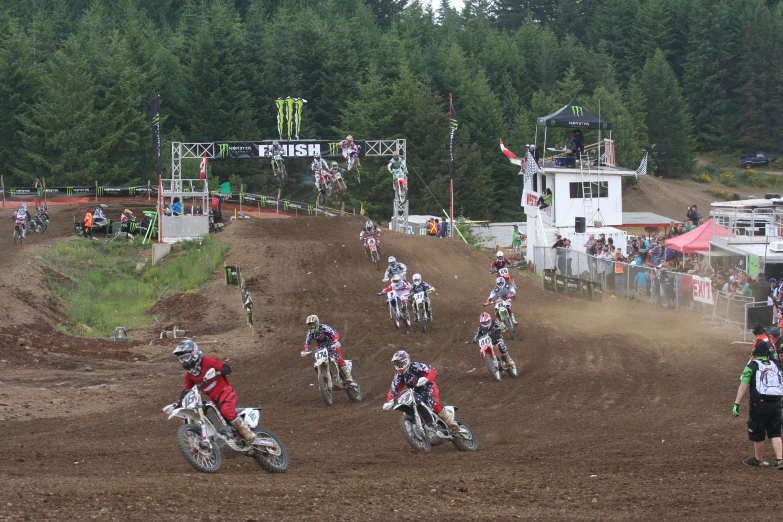 a group of people on dirt bikes racing down a track
