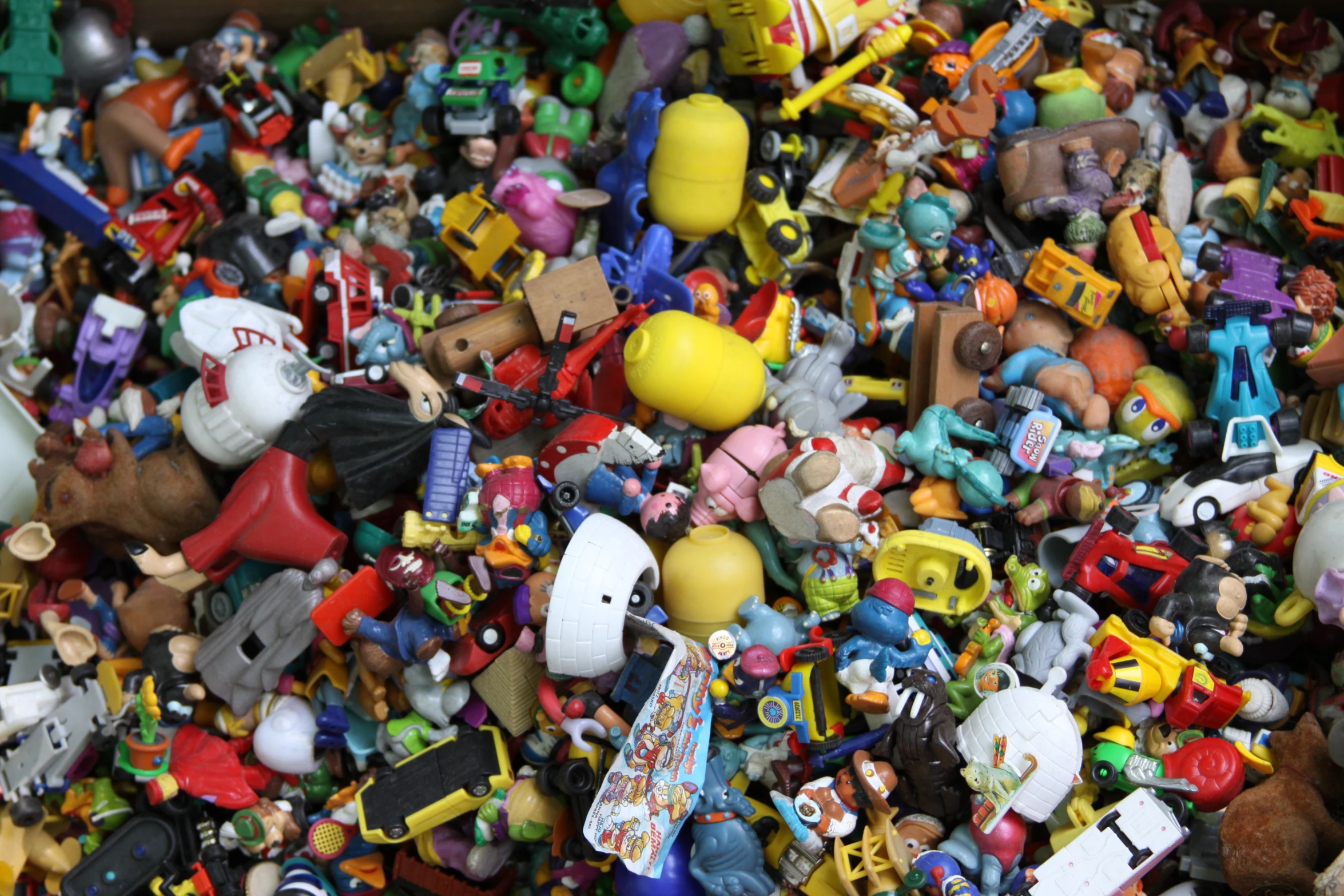 many toys are piled up together in a bin