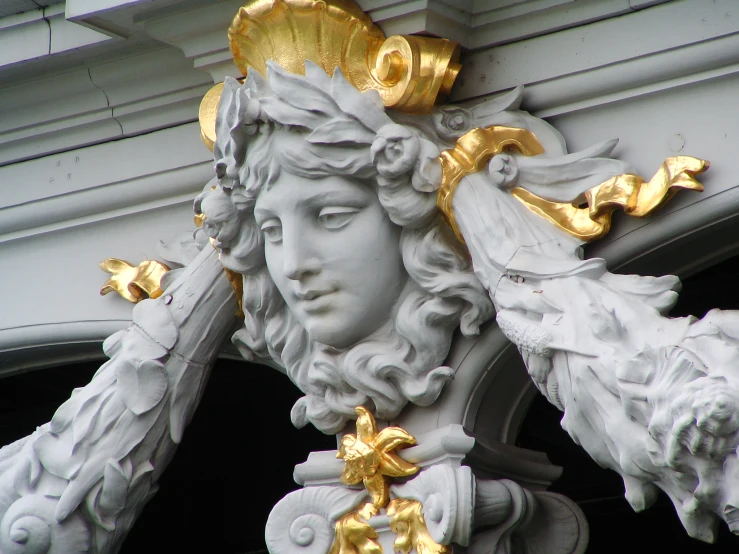 the statue of the lady with gold flowers is located under the roof