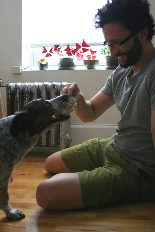 the man has a dog by his side to pet it