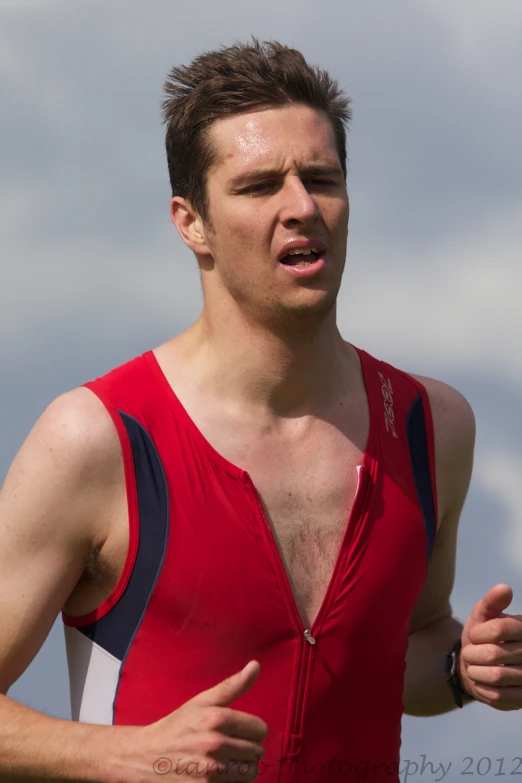 a man in a red vest on a field