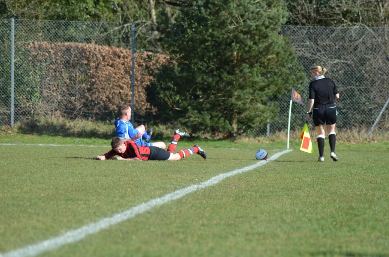 the young men are competing for the soccer ball