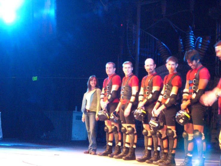 a bunch of men on stage posing for the camera