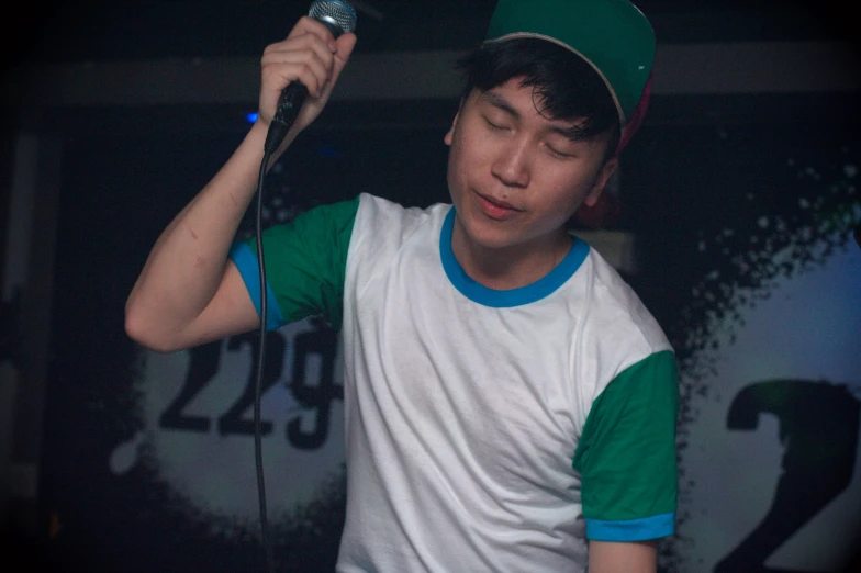 boy singing with microphone in his hands at the concert