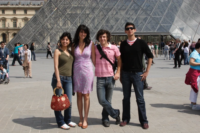 three friends standing outside in front of a pyramid