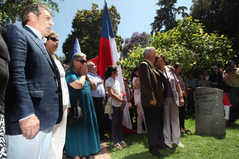 people waiting in line at grave ceremony to receive flags