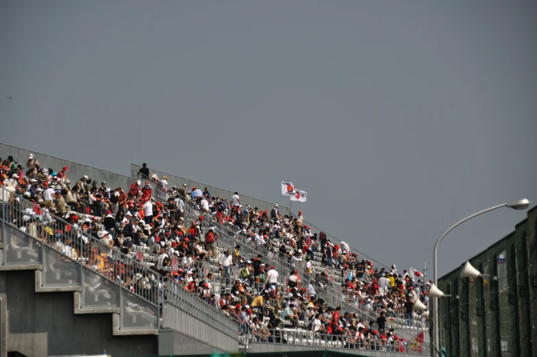 a very large group of people are on a bridge