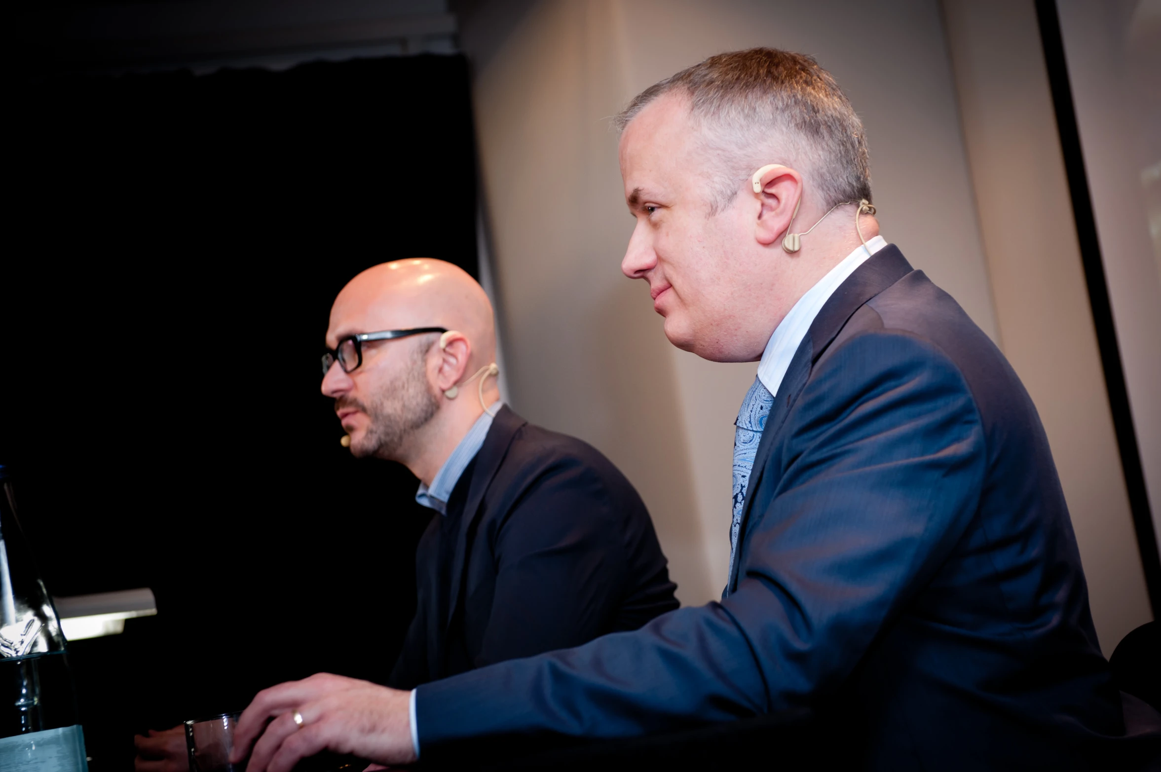 two men in suits and ties next to each other