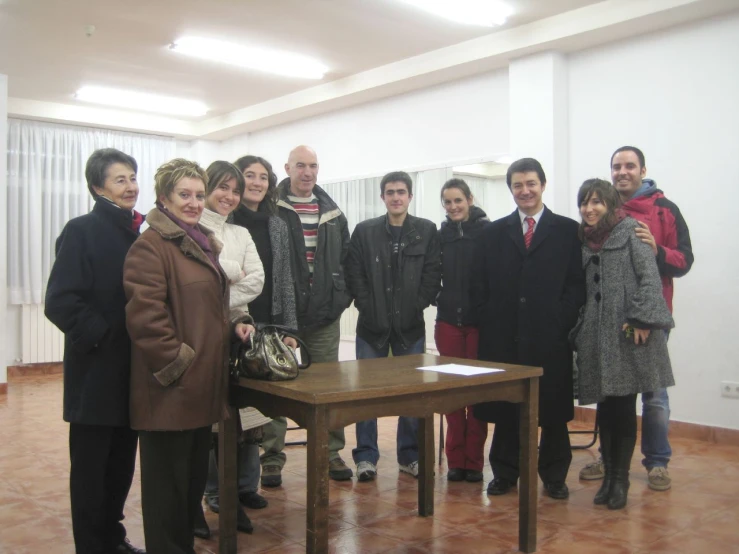 a group of people standing next to each other in an apartment