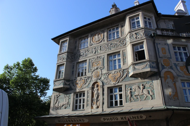 an ornate building with people and decorations on the facade