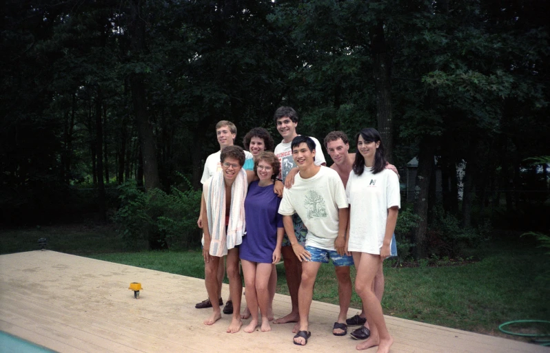 a group of people standing around on a wooden platform