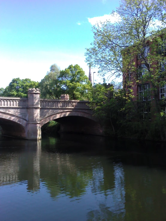 a bridge with a stone structure crossing over water