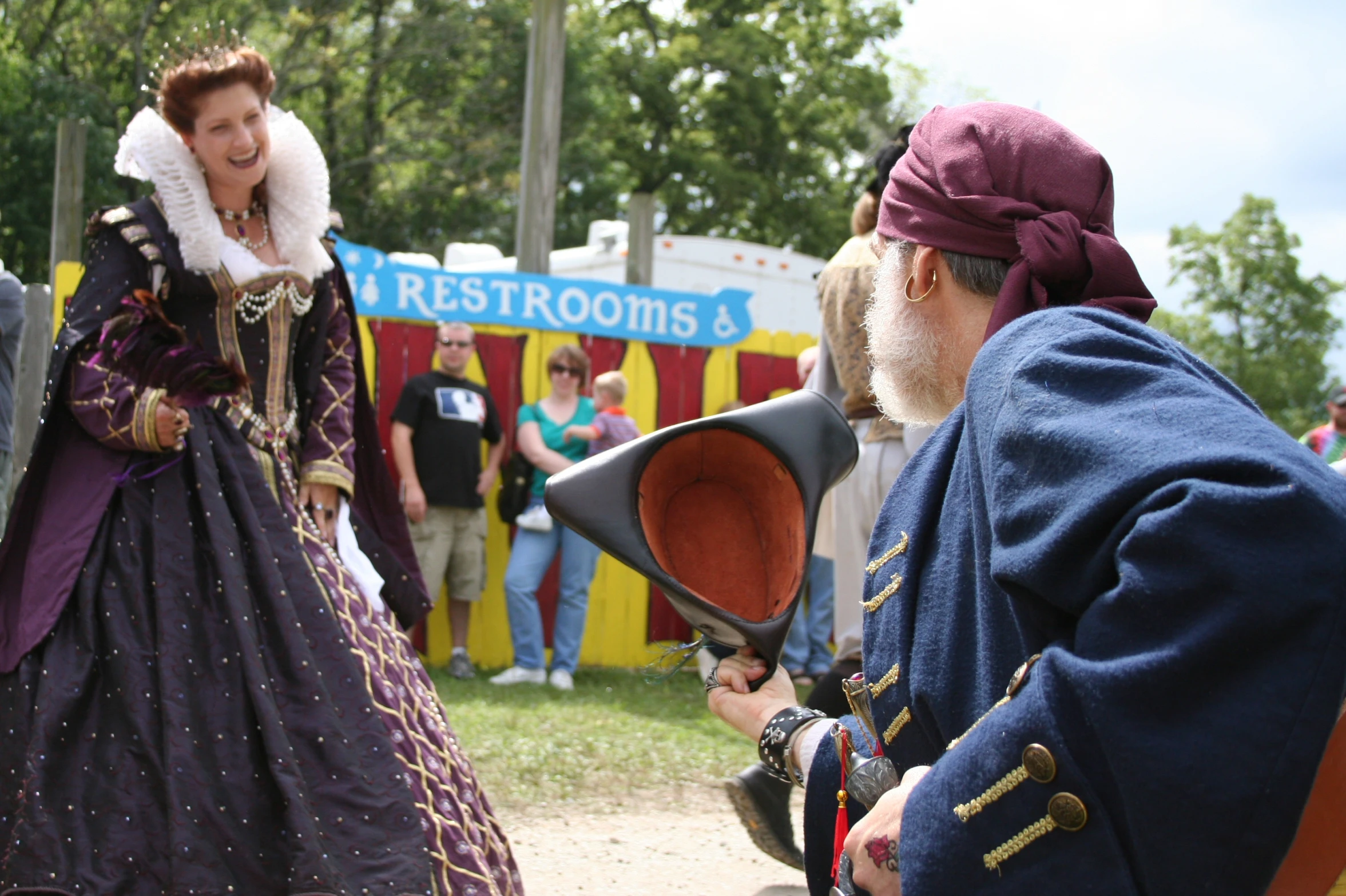 a woman in renaissance clothes talking to two other women