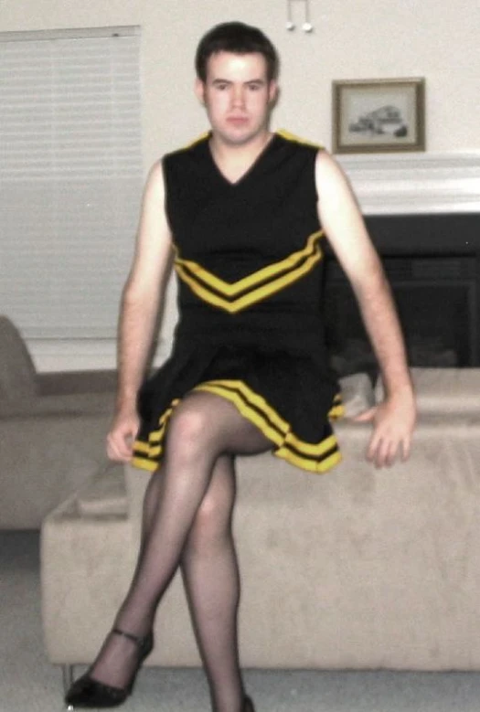 a man is sitting on a couch in dress