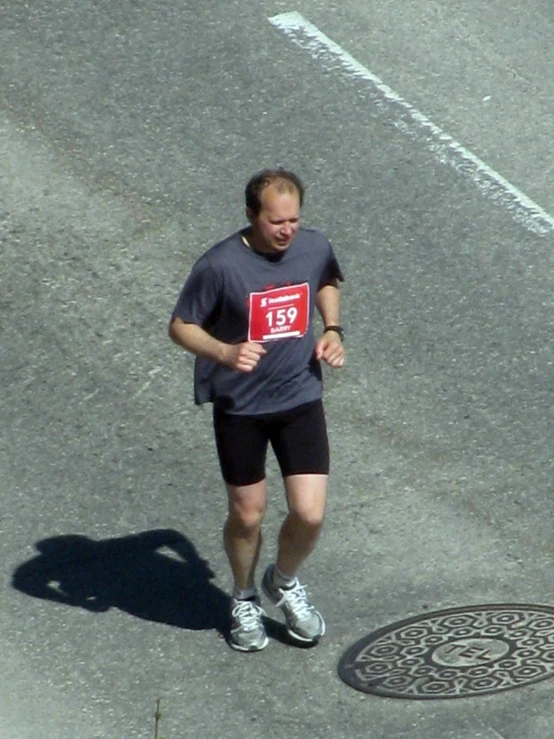 a man in a race running down a street