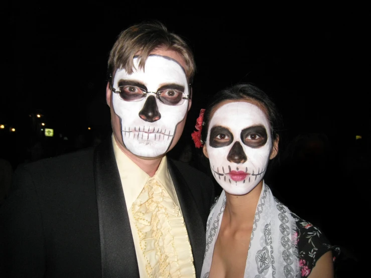 a man and a woman in their skeleton makeup
