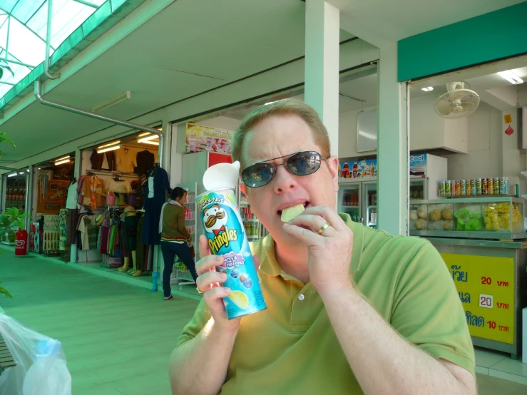 a man eating a bottle of jelly in a building