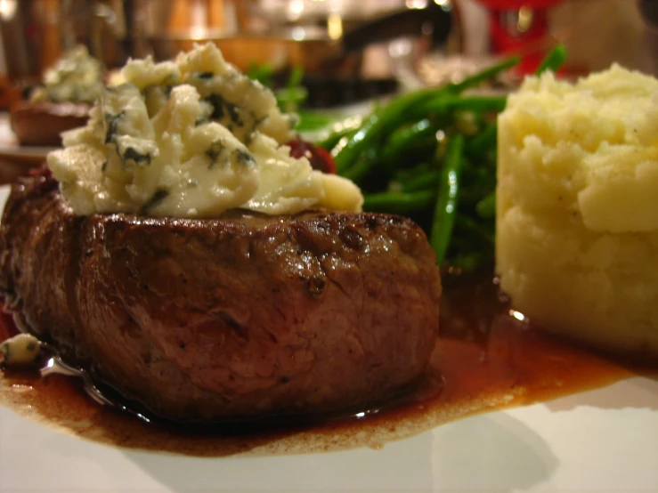 beef and mashed potatoes sit on the table with sauce