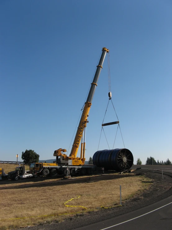 large crane lifting oil from a tanker truck
