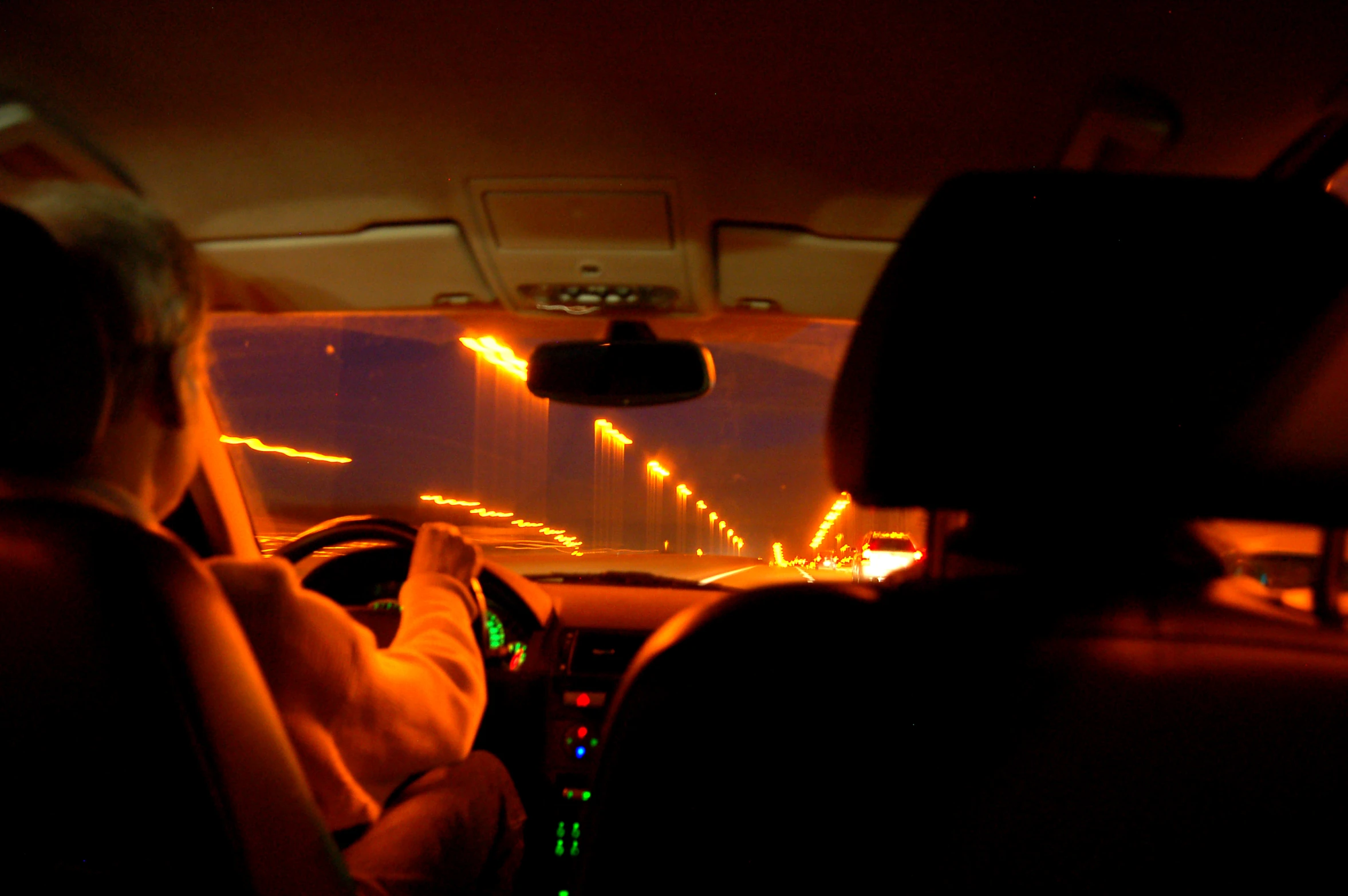 a person sits in the backseat of a car