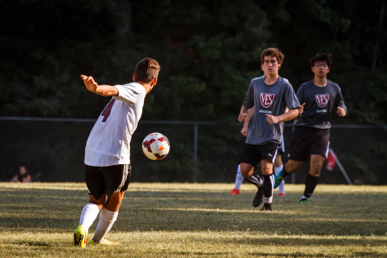 boys are playing soccer on a soccer field